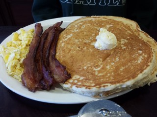 Hungry Man breakfast: shortstack, four pieces bacon, scrambled eggs.